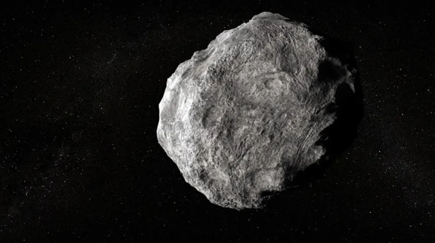 Nieregularna, szara asteroida z kraterami na tle czarnej przestrzeni kosmicznej pełnej gwiazd.